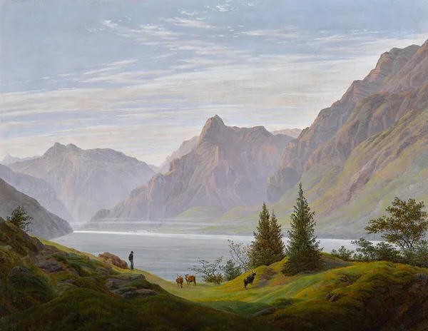 A Romantic landscape of a mountain lake framed by a green valley.